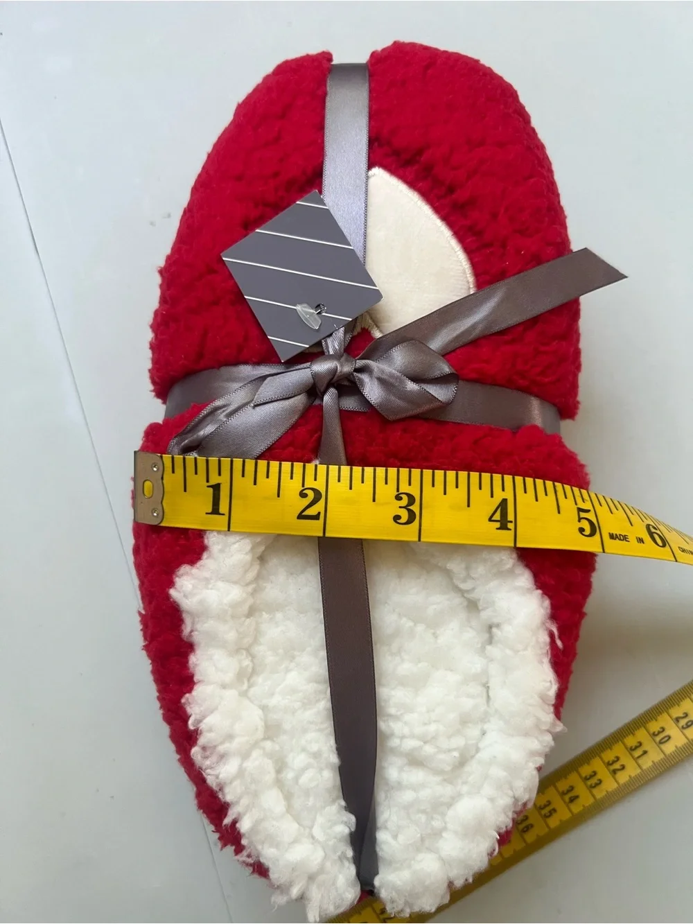 Red & white fuzzy slippers with white heart-shaped patch
